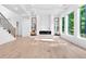 Modern living room with fireplace, large windows, hardwood floors, and staircase access at 801 Braselton Hwy, Lawrenceville, GA 30043