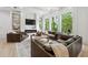 Bright living room with modern fireplace, hardwood floors and large windows with wooded view at 801 Braselton Hwy, Lawrenceville, GA 30043