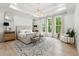 Gorgeous main bedroom features a tray ceiling, large windows, and elegant decor at 801 Braselton Hwy, Lawrenceville, GA 30043