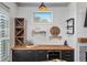 Stylish bar area with custom cabinetry, countertop, wine fridge, and elegant display shelves at 1186 Lincoln Dr, Marietta, GA 30066