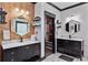 A modern bathroom boasts dual vanities with marble countertops, hexagonal mirrors and elegant fixtures at 1186 Lincoln Dr, Marietta, GA 30066
