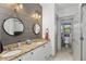 Modern bathroom with double vanity, granite countertops, and stylish mirrors, plus a toilet in a small adjacent room at 1186 Lincoln Dr, Marietta, GA 30066