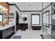 A modern bathroom boasts an elegant black freestanding tub, dual vanities and a glass enclosed shower at 1186 Lincoln Dr, Marietta, GA 30066