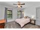 Cozy bedroom with carpet flooring, ceiling fan, and natural light from a large window at 1186 Lincoln Dr, Marietta, GA 30066