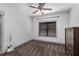 Neat bedroom featuring neutral carpet, white walls, a ceiling fan and a dark wooden dresser at 1186 Lincoln Dr, Marietta, GA 30066