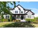 Stunning two-story home featuring stone and white siding, a welcoming front porch and manicured landscaping at 1186 Lincoln Dr, Marietta, GA 30066