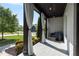Inviting covered porch with outdoor seating, decorative curtains, and stylish lighting fixtures at 1186 Lincoln Dr, Marietta, GA 30066