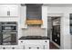 Close-up of a kitchen with stainless steel oven and range with a stylish backsplash at 1186 Lincoln Dr, Marietta, GA 30066