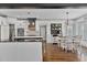 Modern kitchen with white cabinetry, stainless steel appliances, black island, and open dining area at 1186 Lincoln Dr, Marietta, GA 30066