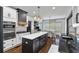 Open concept kitchen with large island, stainless steel appliances, and adjacent dining area at 1186 Lincoln Dr, Marietta, GA 30066