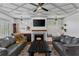 Spacious living room with coffered ceilings, fireplace, large screen tv, and comfortable leather sofas at 1186 Lincoln Dr, Marietta, GA 30066