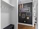 Mudroom area with black accent wall, coat hooks, and decorative home decor at 1186 Lincoln Dr, Marietta, GA 30066