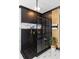 A modern shower boasts black herringbone tile, gold hardware and an inset marble shelving nook at 1186 Lincoln Dr, Marietta, GA 30066