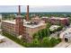 Aerial view of brick building complex with mature trees and smokestacks and parking at 170 Boulevard Se # H405, Atlanta, GA 30312