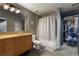Bathroom with wood vanity and shower-tub combination with concrete floors at 170 Boulevard Se # H405, Atlanta, GA 30312