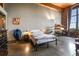 Comfortable primary bedroom with exposed brick wall, shelving, and window providing natural light at 170 Boulevard Se # H405, Atlanta, GA 30312