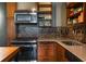Close view of a well-equipped kitchen featuring stainless appliances and attractive mosaic tile backsplash at 170 Boulevard Se # H405, Atlanta, GA 30312