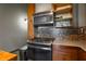 Close-up of the gas range and mosaic backsplash in a compact and functional kitchen space at 170 Boulevard Se # H405, Atlanta, GA 30312