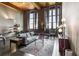 Bright living area featuring exposed brick, high ceilings, and large windows providing ample natural light at 170 Boulevard Se # H405, Atlanta, GA 30312