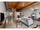 Open-concept living space with exposed wood ceiling beams, a modern kitchen, and comfortable seating area at 170 Boulevard Se # H405, Atlanta, GA 30312