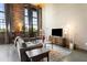 Cozy living room with exposed brick wall, comfortable seating, and stylish decor in a loft setting at 170 Boulevard Se # H405, Atlanta, GA 30312
