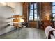 Modern office with exposed brick, concrete floors, and shelving in a well-lit room at 170 Boulevard Se # H405, Atlanta, GA 30312