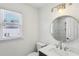 The modern bathroom features a sleek vanity, round mirror, and shower with tiled walls at 4581 Hickory Run Nw Ct, Acworth, GA 30102