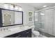 Modern bathroom with double sinks, marble countertops, and a glass-enclosed shower at 4581 Hickory Run Nw Ct, Acworth, GA 30102