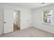 The bedroom features fresh paint, neutral carpet, a window, and two doors with black handles at 4581 Hickory Run Nw Ct, Acworth, GA 30102