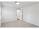 Bright bedroom features fresh paint, neutral carpet, window, and a door with a black handle at 4581 Hickory Run Nw Ct, Acworth, GA 30102