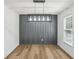 Modern dining area with hardwood floors, stylish lighting, and a contemporary accent wall at 4581 Hickory Run Nw Ct, Acworth, GA 30102
