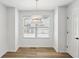 Cozy dining area with hardwood floors, modern chandelier, and a bright window view at 4581 Hickory Run Nw Ct, Acworth, GA 30102
