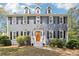 Charming two-story home with gray siding, black shutters, and a bright orange front door at 4581 Hickory Run Nw Ct, Acworth, GA 30102