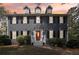 Beautiful two-story home with an orange front door, black shutters, and manicured landscaping at 4581 Hickory Run Nw Ct, Acworth, GA 30102