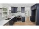 Modern kitchen featuring navy cabinets, stainless steel appliances, and a stylish subway tile backsplash at 4581 Hickory Run Nw Ct, Acworth, GA 30102