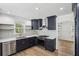 Bright kitchen showcasing navy cabinets, stainless steel appliances, and a modern subway tile backsplash at 4581 Hickory Run Nw Ct, Acworth, GA 30102