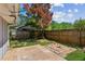 Backyard with a patio, string lights, privacy fence and mature trees at 553 Candlewood Dr, Stone Mountain, GA 30088