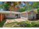 Inviting backyard features a cozy patio, string lights, and lush greenery, perfect for outdoor relaxation and entertainment at 553 Candlewood Dr, Stone Mountain, GA 30088