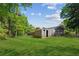 Large green backyard with shed, mature trees, and ample space at 553 Candlewood Dr, Stone Mountain, GA 30088