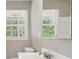 Bathroom featuring a sleek sink, mirror, and window for natural light at 553 Candlewood Dr, Stone Mountain, GA 30088