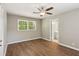 Comfortable bedroom with modern flooring, neutral paint, a ceiling fan, and easy access to the bathroom at 553 Candlewood Dr, Stone Mountain, GA 30088
