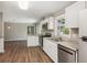 Well-lit kitchen with white cabinets, stainless steel appliances, and views to the living area through a serving hatch at 553 Candlewood Dr, Stone Mountain, GA 30088