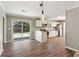 Bright, open-concept kitchen with white cabinets, stainless steel appliances, and a sliding glass door to the backyard at 553 Candlewood Dr, Stone Mountain, GA 30088