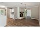 Cozy living room with a brick fireplace, open layout, and seamless flooring at 553 Candlewood Dr, Stone Mountain, GA 30088