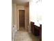 Bathroom featuring tile floors, dark wood vanity cabinets, and access to a walk-in closet at 1186 Ridenour Blvd # 5, Kennesaw, GA 30152