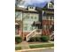 Charming townhouse featuring a blend of brick and siding, complemented by well-maintained landscaping at 1186 Ridenour Blvd # 5, Kennesaw, GA 30152