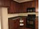 Kitchen featuring dark cabinets, granite countertops, modern appliances, and hardwood floors at 1186 Ridenour Blvd # 5, Kennesaw, GA 30152