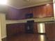Well-equipped kitchen with stainless steel appliances, dark cabinetry, and granite countertops at 1186 Ridenour Blvd # 5, Kennesaw, GA 30152