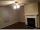 Cozy living room with a fireplace, ceiling fan, and warm lighting, perfect for relaxation at 1186 Ridenour Blvd # 5, Kennesaw, GA 30152