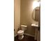 Charming powder room featuring a pedestal sink and a decorative oval mirror at 1186 Ridenour Blvd # 5, Kennesaw, GA 30152